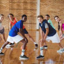 Students Stretching in Gymnasium